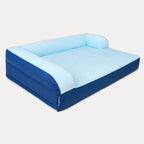 An inflatable pet bed with a light blue plush top and backrest, and a Royal blue base and sides, shown on a light gray background. The brand name 'PUPPO' is visible on a small tag on the side.