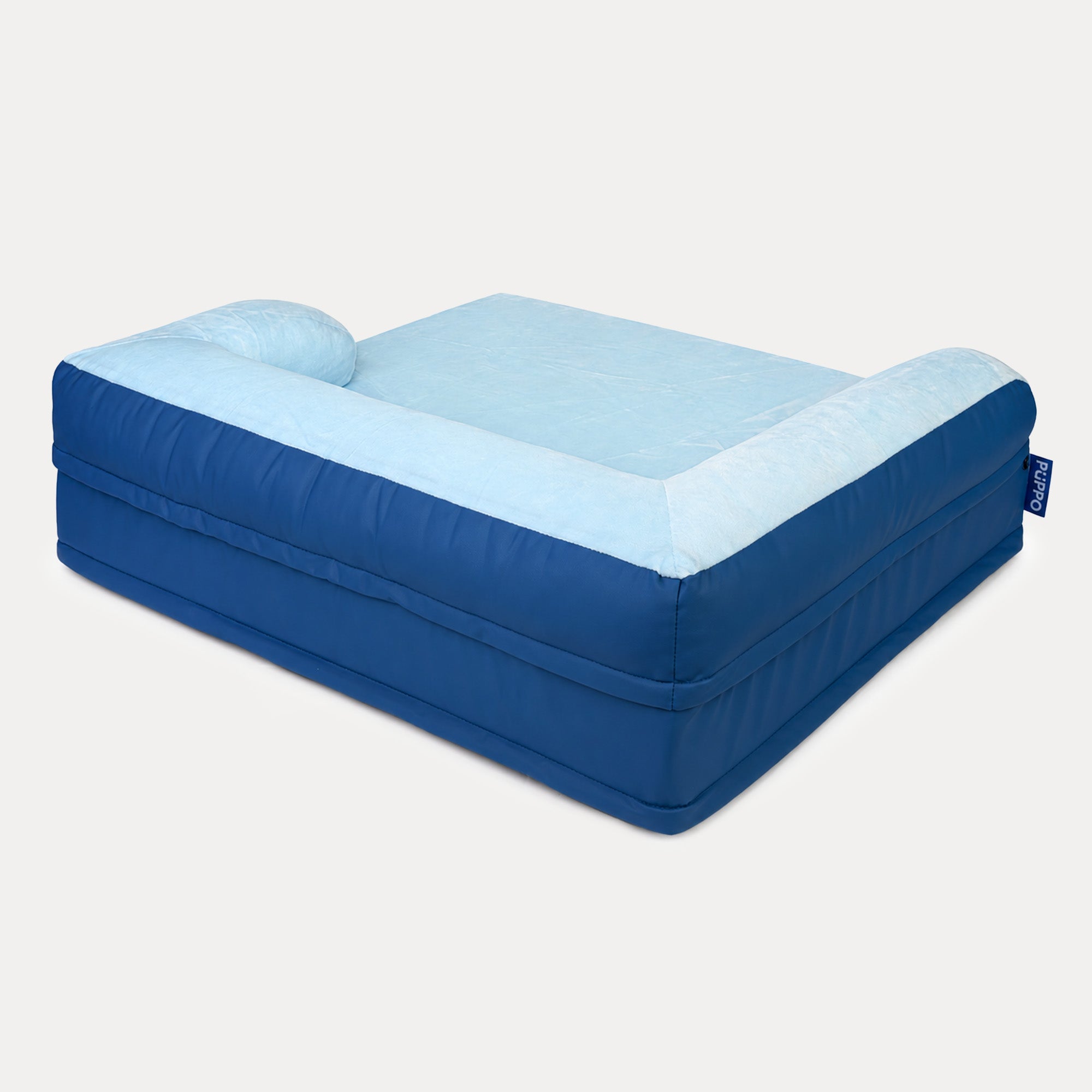 An inflatable pet bed with a Royal blue exterior and a light blue plush interior, shown on a solid light gray background.